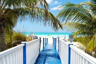 blue and white wooden bride near ocean by Juan Rojas courtesy of Unsplash.