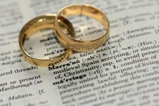 two gold-colored rings on paper by Sandy Millar courtesy of Unsplash.