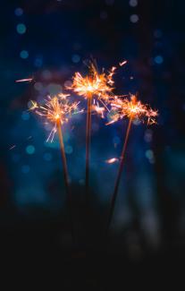 three sparkler sticks by Tim Zänkert courtesy of Unsplash.